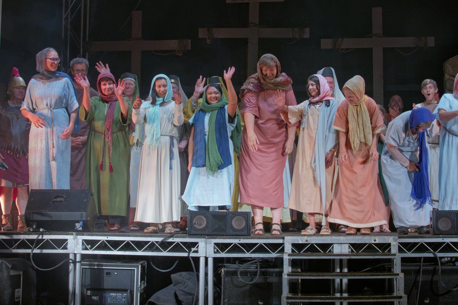 The company takes a bow, with three wooden crosses behind them